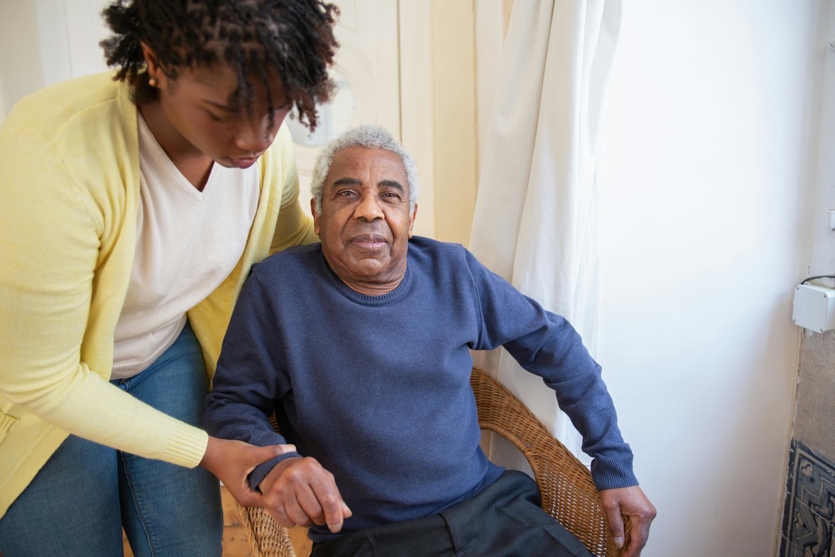 Millennial daughter supporting her aging father at home, illustrating the realities of caregiving and end-of-life planning in Ontario.